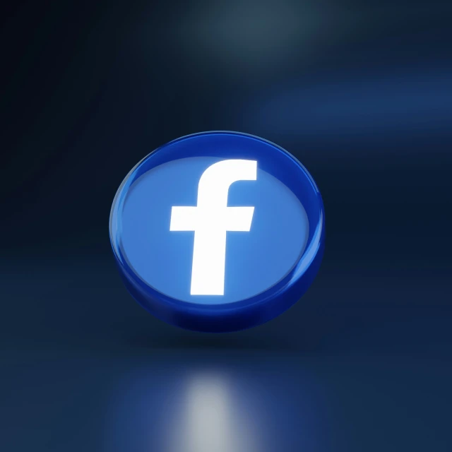 a shiny blue facebook on placed in a dark room