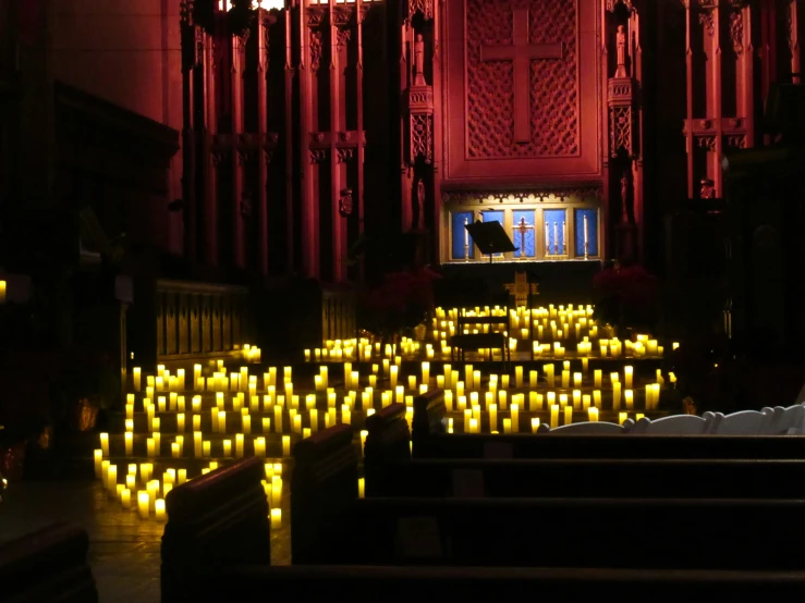 a church with a set of benches with candles placed on them