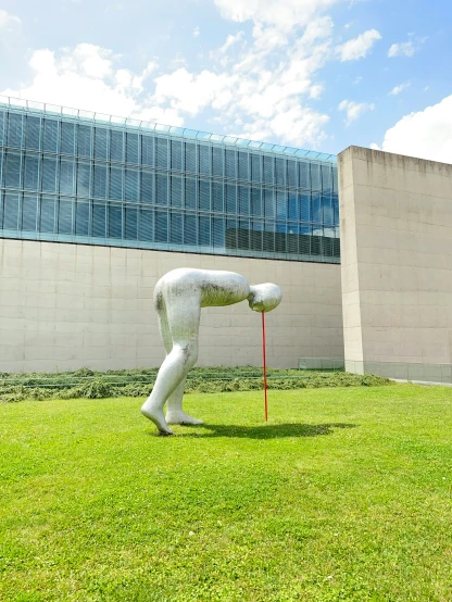 a person sculpture standing in the grass