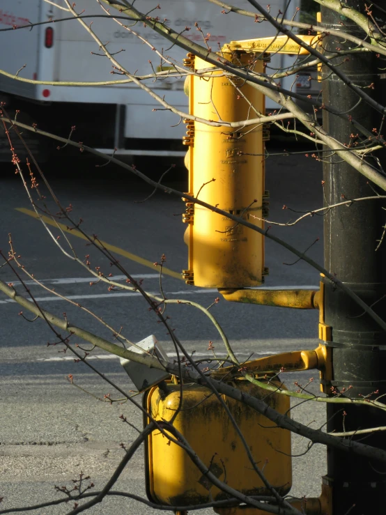 a yellow traffic light on the side of the road