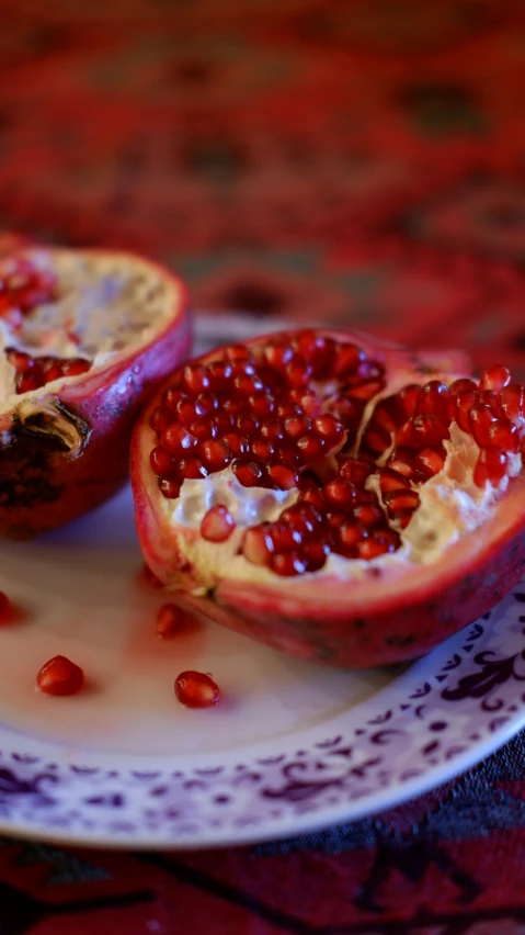 a plate with a pomegranate on top of it