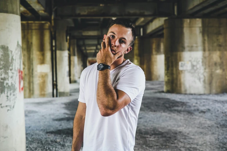 a man in white is standing in a garage