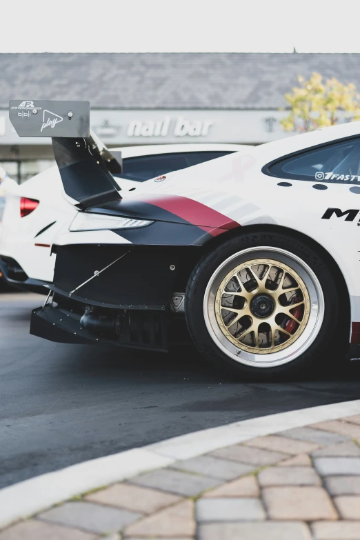 a white sports car parked on the side of the street