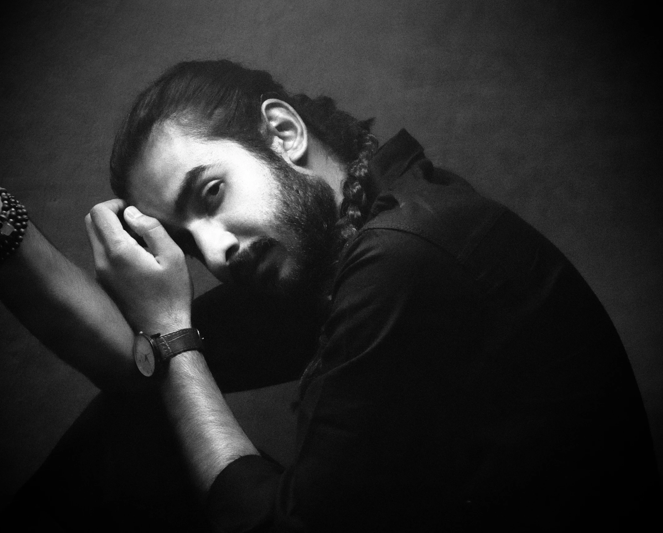 a black and white po of a man in a dimly lit room