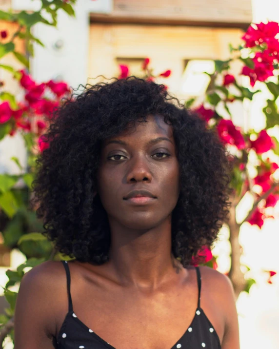 a black woman wearing a polka dot blouse