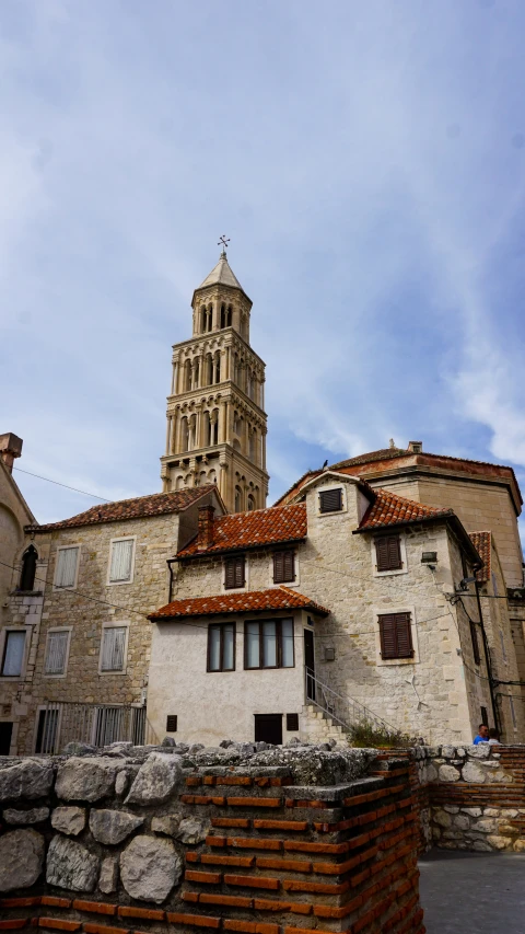 an old tower sits atop some old buildings