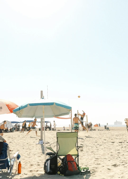 a group of people that are sitting under some umbrellas