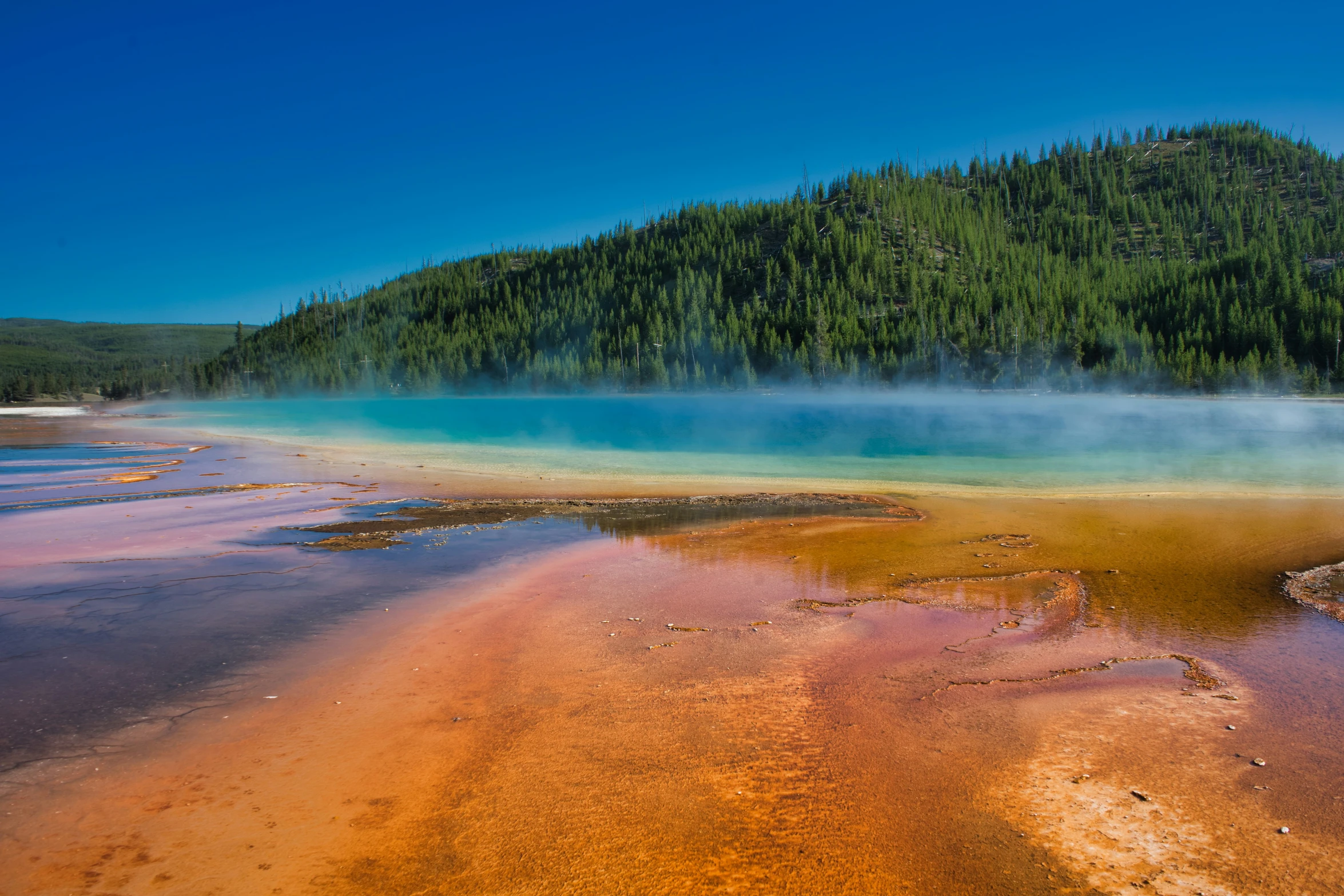 a view of some water and the mountains