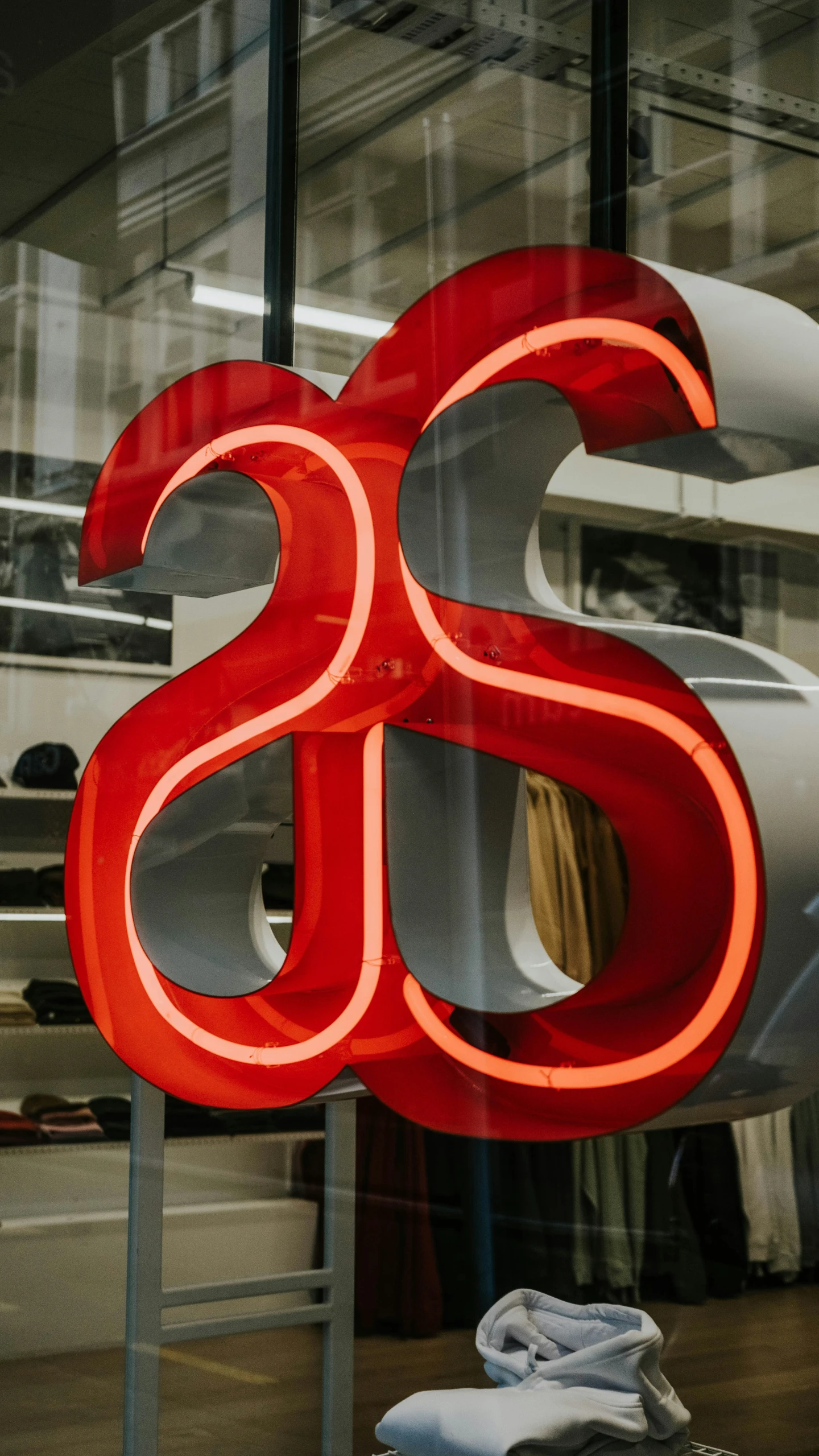 a red neon letter that is inside a glass window