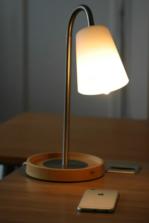the iphone and lamp are set up on a table