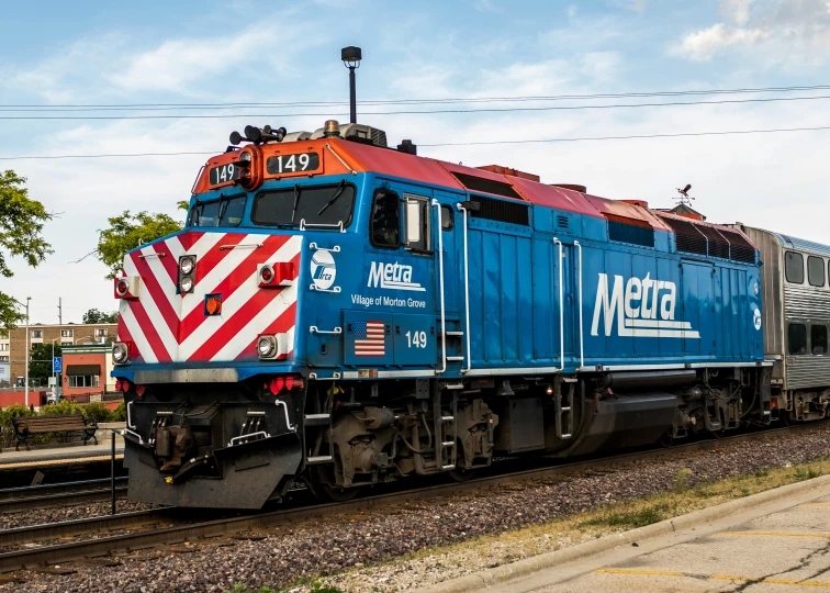 a train traveling down tracks in a rural setting