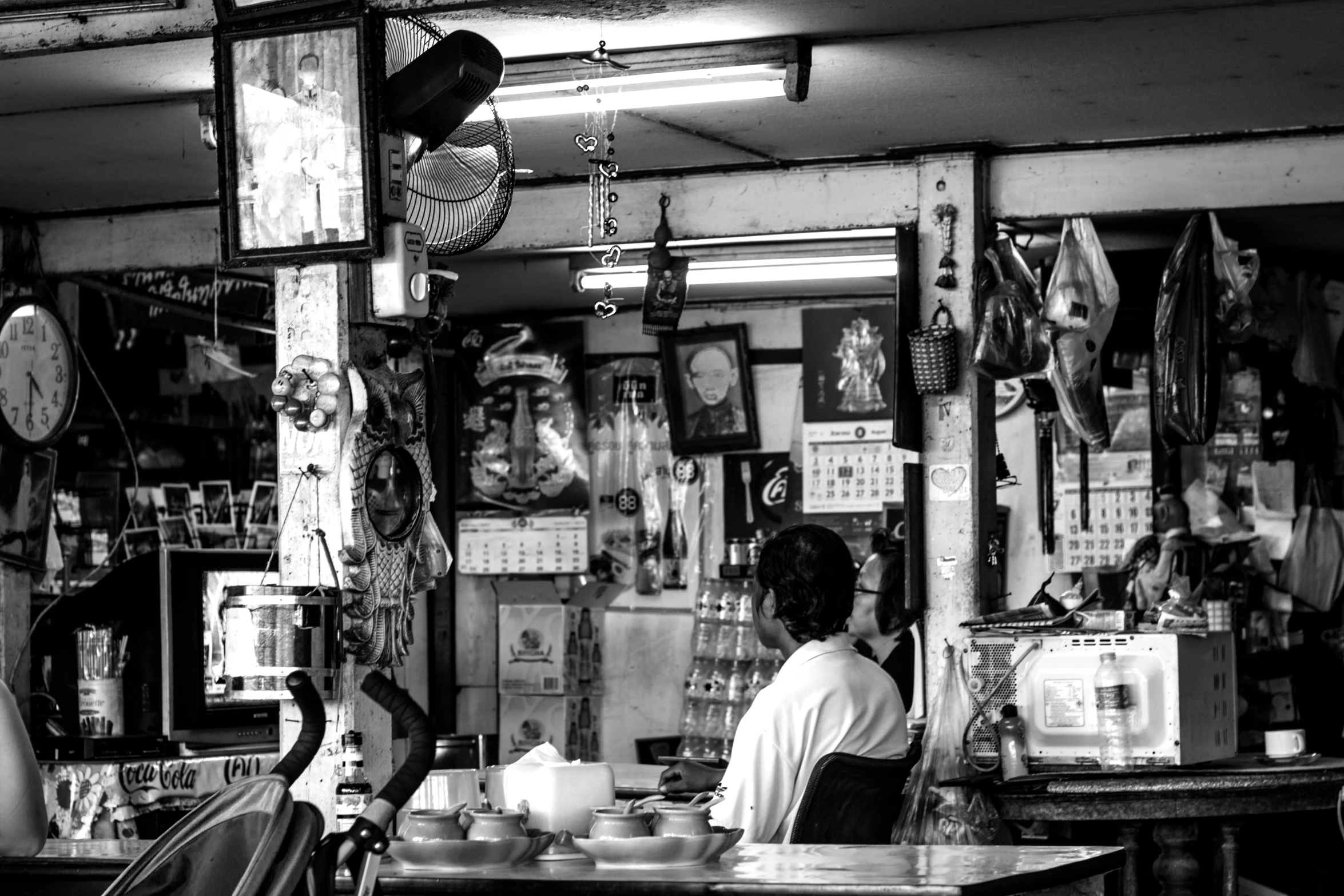 some people sitting in chairs in front of a store