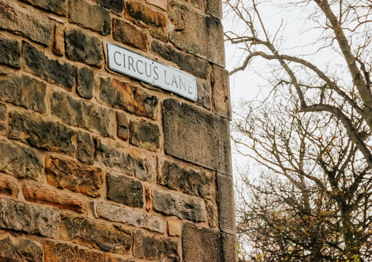 a sign on the side of a stone building