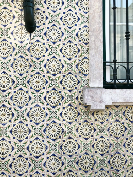 a decorative tiled wall on an outside building