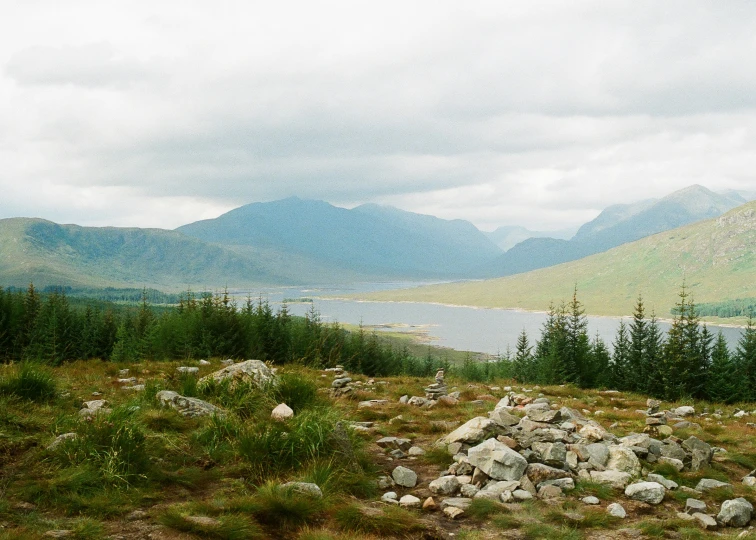 two people walk down a path in the mountains