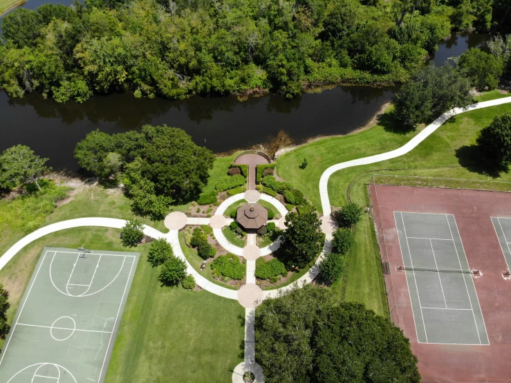 a bird's eye view of a tennis court in the middle of the woods