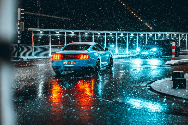 a car driving down a street in the rain