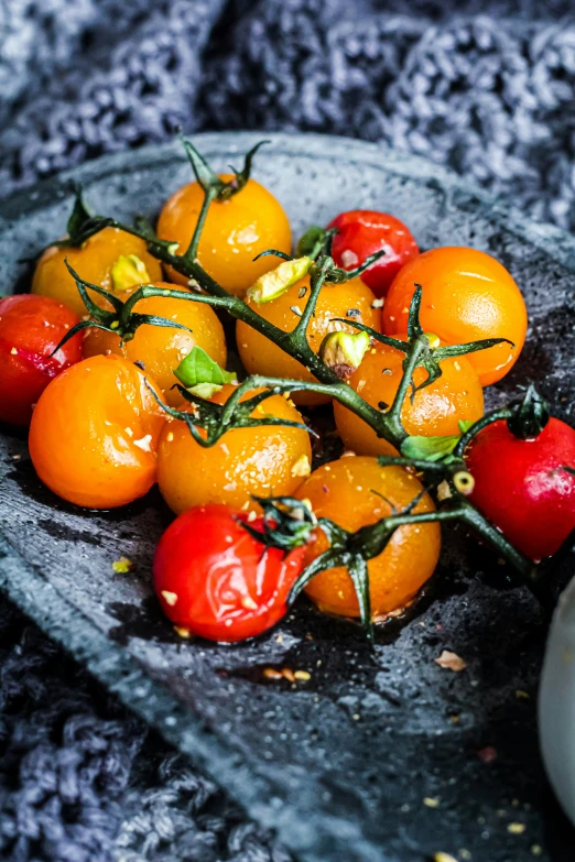 a bowl full of orange and red tomatoes