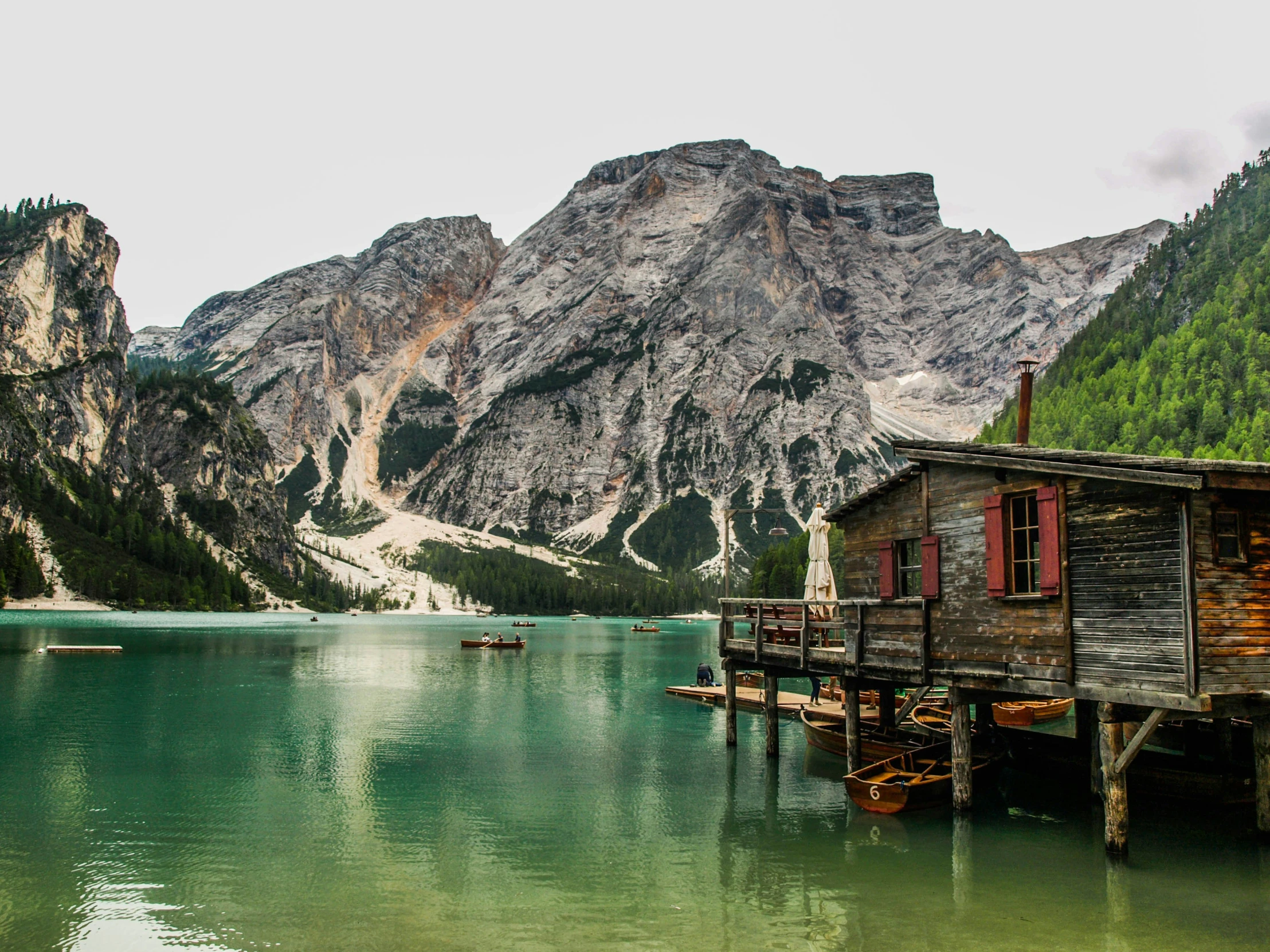 a mountain with some boats in it and people standing outside