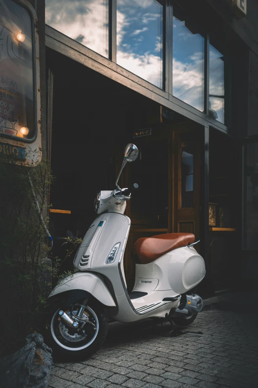 a motor scooter parked in front of a building