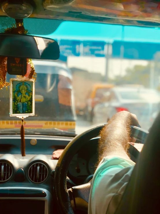 the inside view from inside a car shows the driver, dashboard, and inside a bus with a man driving