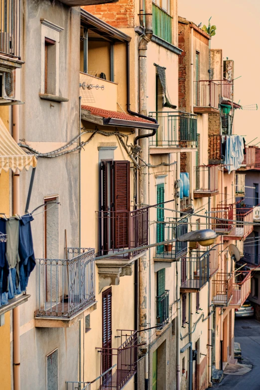 a number of buildings with some blue and yellow clothes hanging out the windows