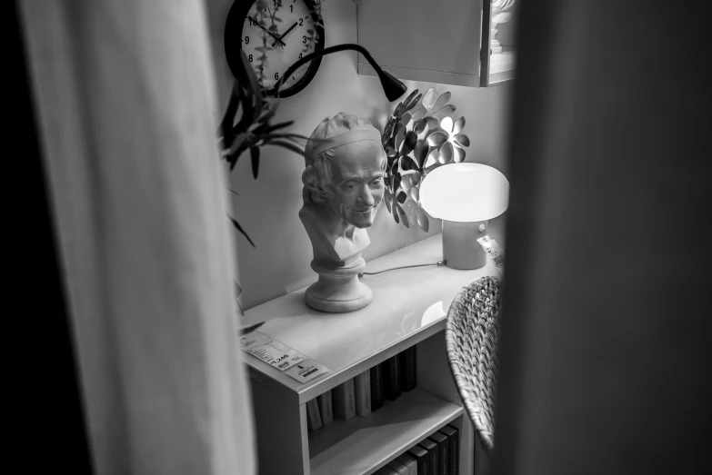 a dark room with books and a lamp on it