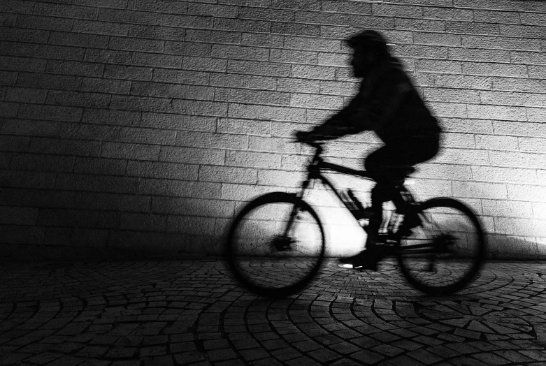 black and white po of a man on a bicycle