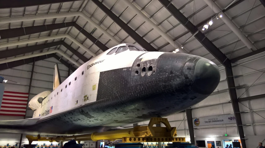 a space shuttle is on display in a hangar