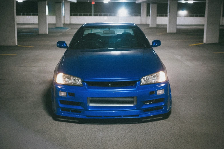 a blue car is parked in a parking garage