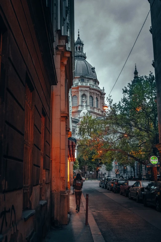 the lady is walking down the street alone