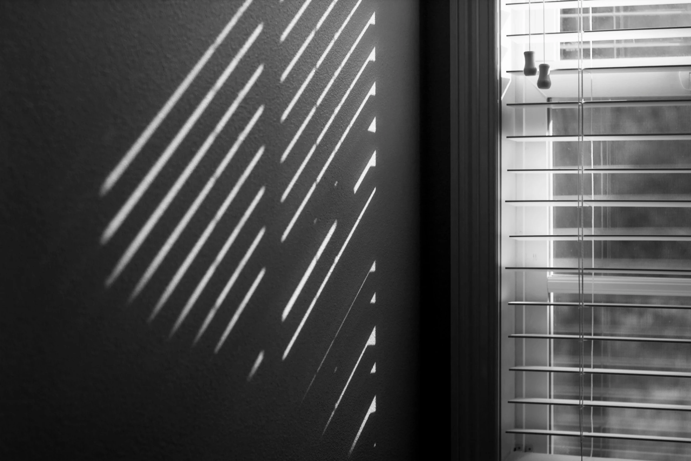 the shadow of a window from the blinds of a window