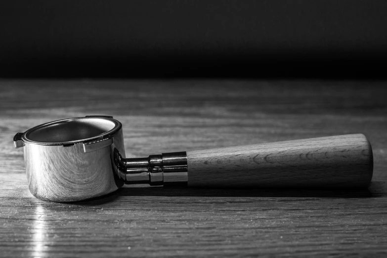 a ring on a wooden table next to a lighter