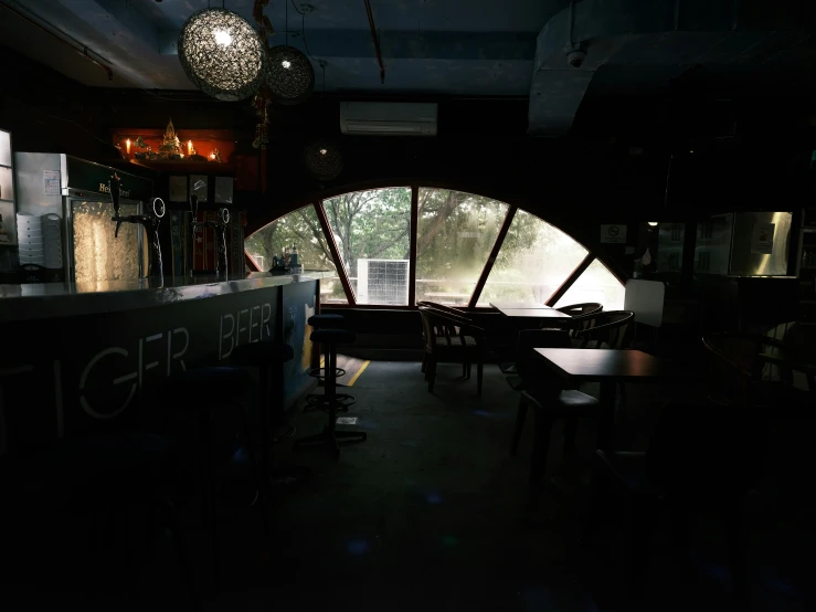 an empty dining room filled with wooden chairs and tables