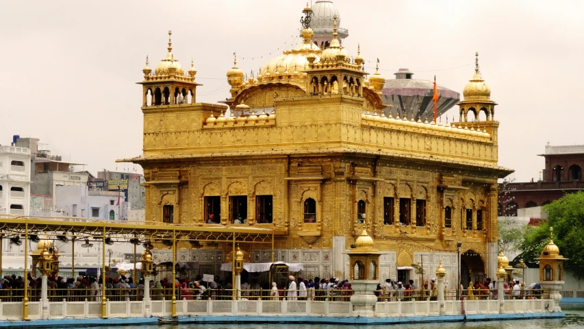 a yellow and golden building on water