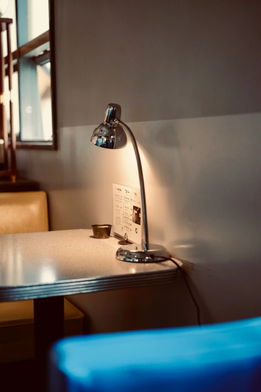 a table lamp sitting on top of a metal table