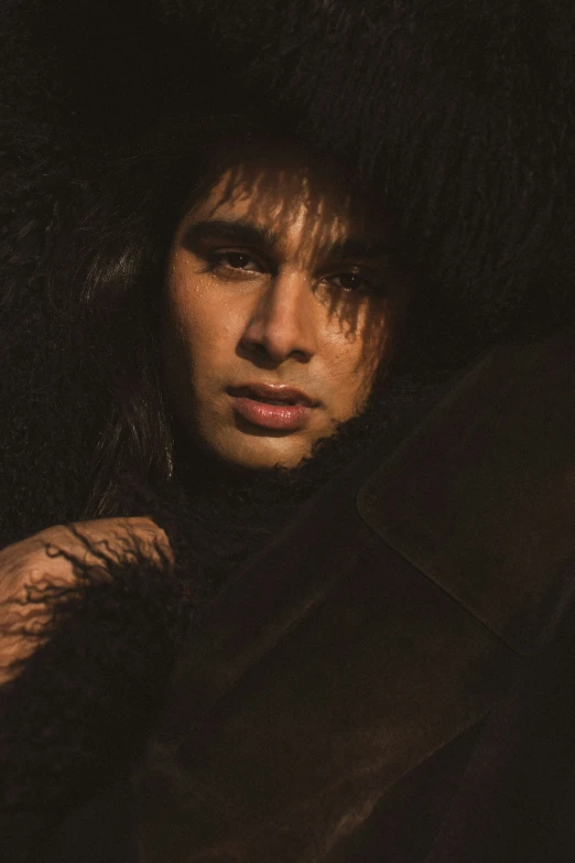 a man is standing outside with long hair