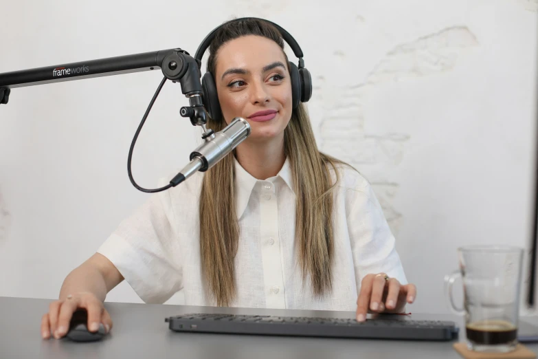 a girl in white shirt and headphones on a desk