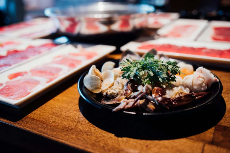 the plate is full of seafood with some other meats