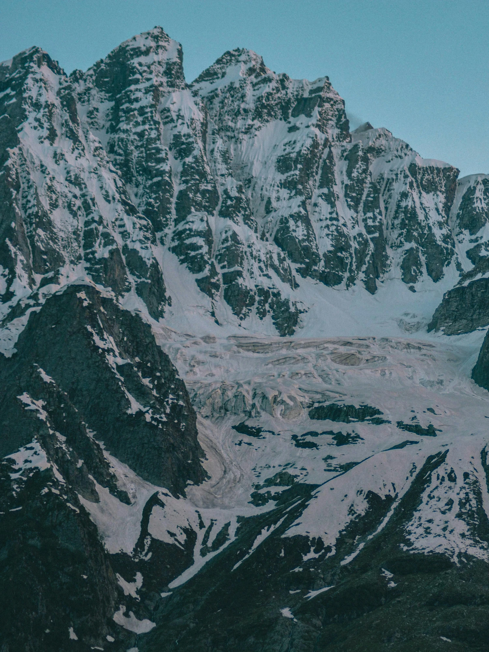 a snowy mountain with some very tall peaks