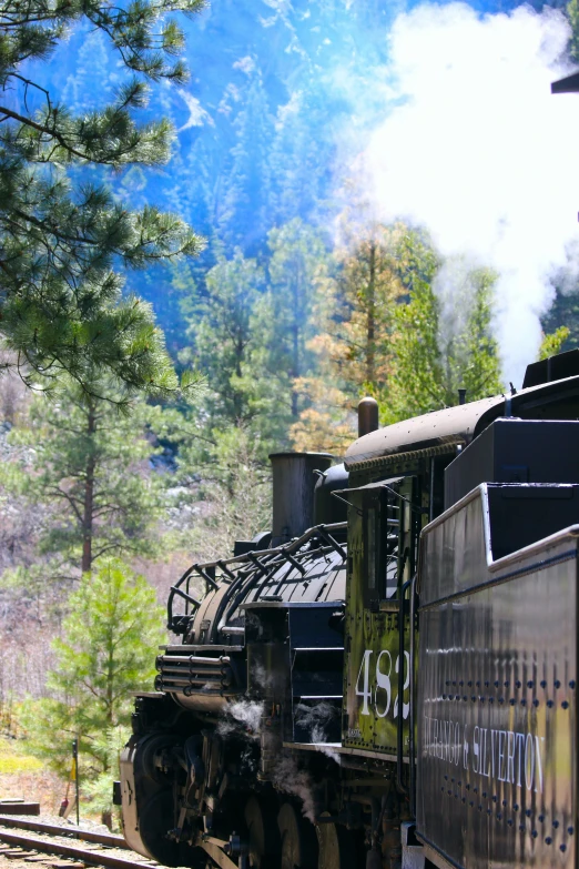 a steam engine train moving in the mountain