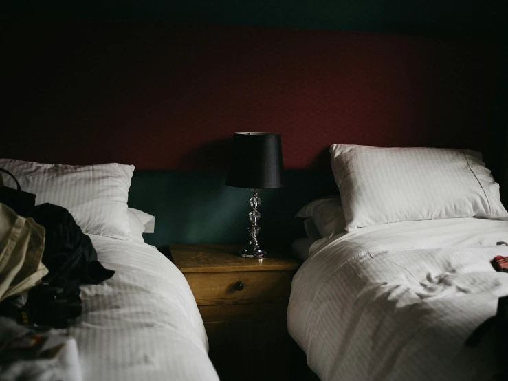 two beds with white blankets sit side by side