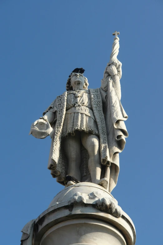 a statue on top of a monument looking upwards