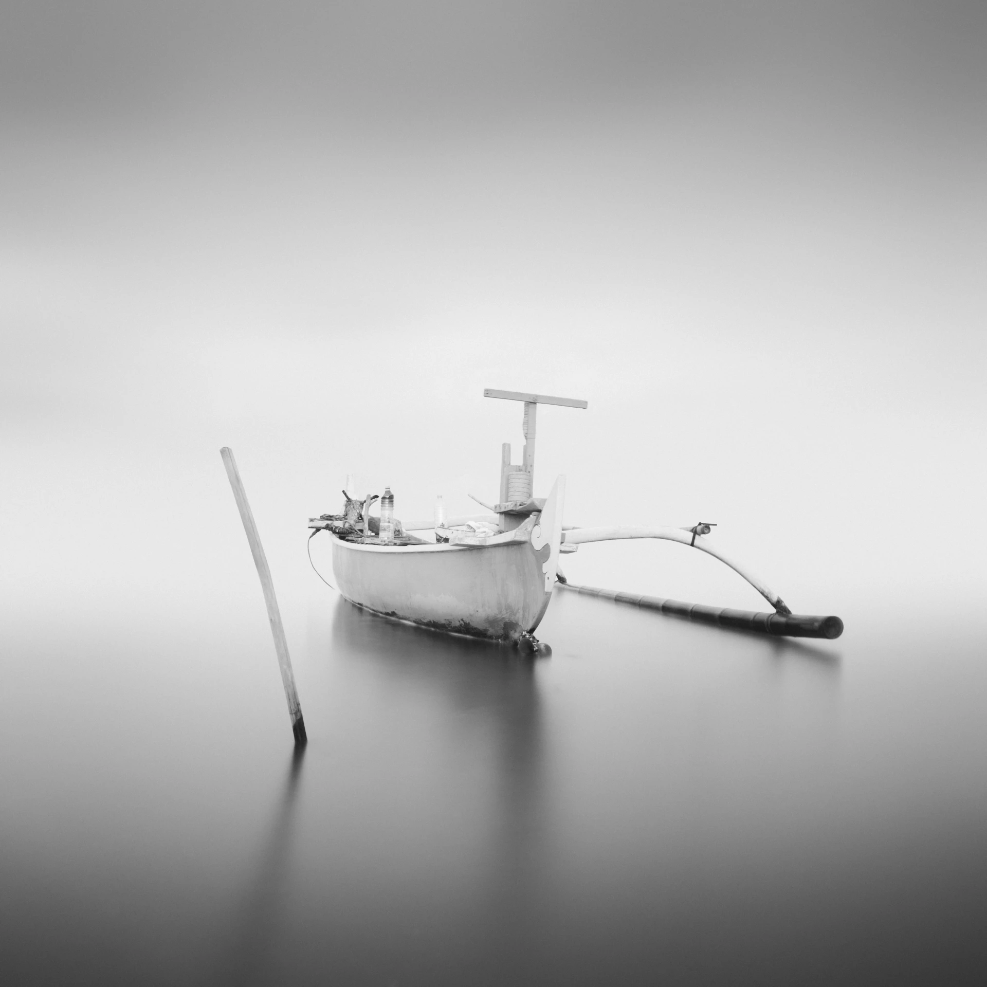 black and white pograph of a fishing boat on a foggy day