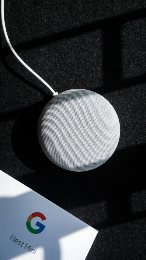 a white google home speaker sitting on a table