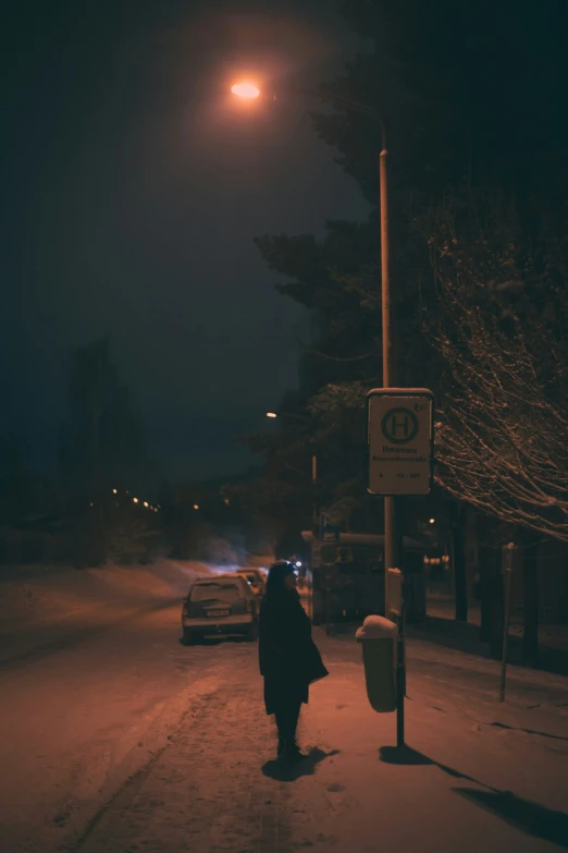 the person is walking down the snowy road