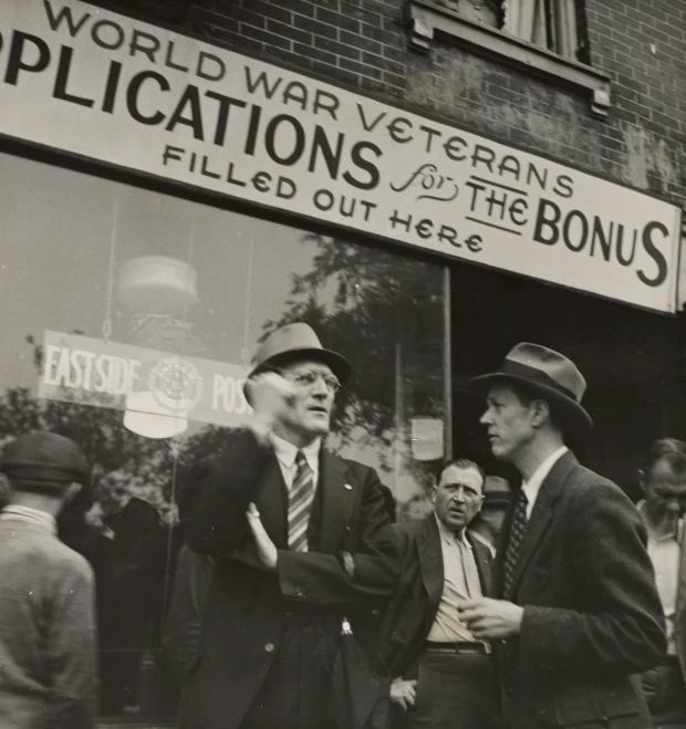 men in business attire talk outside of a building