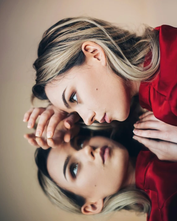 two women are looking at their face in the mirror