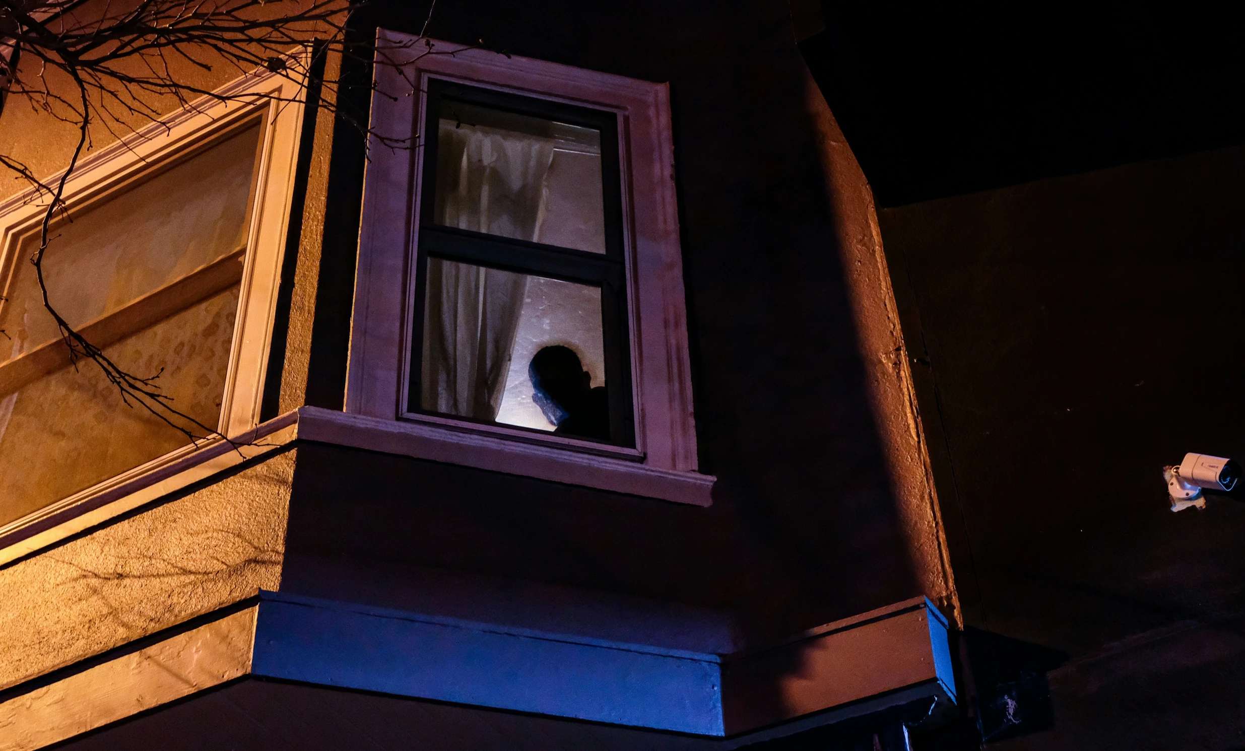 woman staring out the window at night