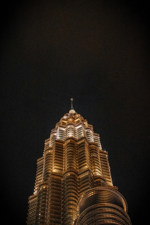 very tall building at night lit up with lights